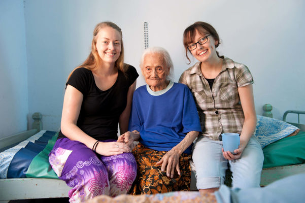 2 Voluntäre mit alter Frau im Altenpflegeprojekt auf Java