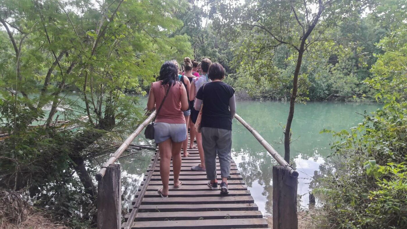 Volunteers walking over bridge on Palawan island