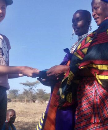 Participant giving card to Maasai people